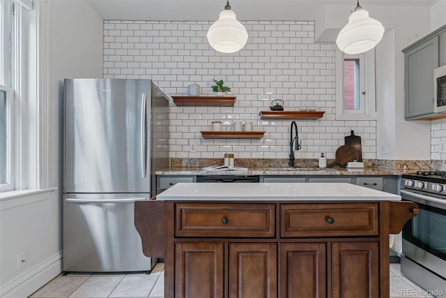 kitchen with open shelves, a sink, stainless steel appliances, decorative backsplash, and light tile patterned floors