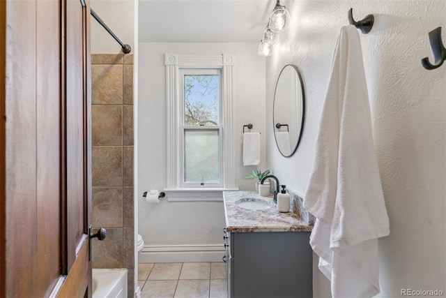 bathroom featuring shower / bathing tub combination, tile patterned flooring, baseboards, vanity, and toilet