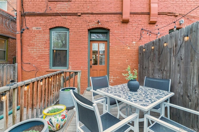 wooden deck with fence and outdoor dining area