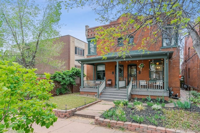 view of front of property featuring a porch and brick siding
