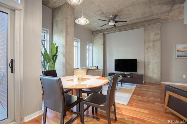 dining room with baseboards, a ceiling fan, and wood finished floors