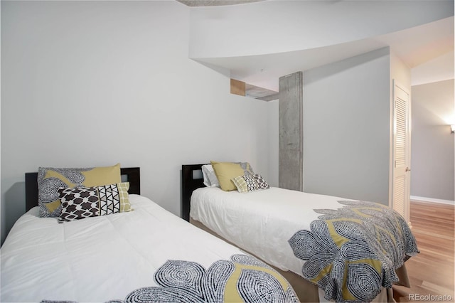 bedroom featuring wood finished floors and baseboards