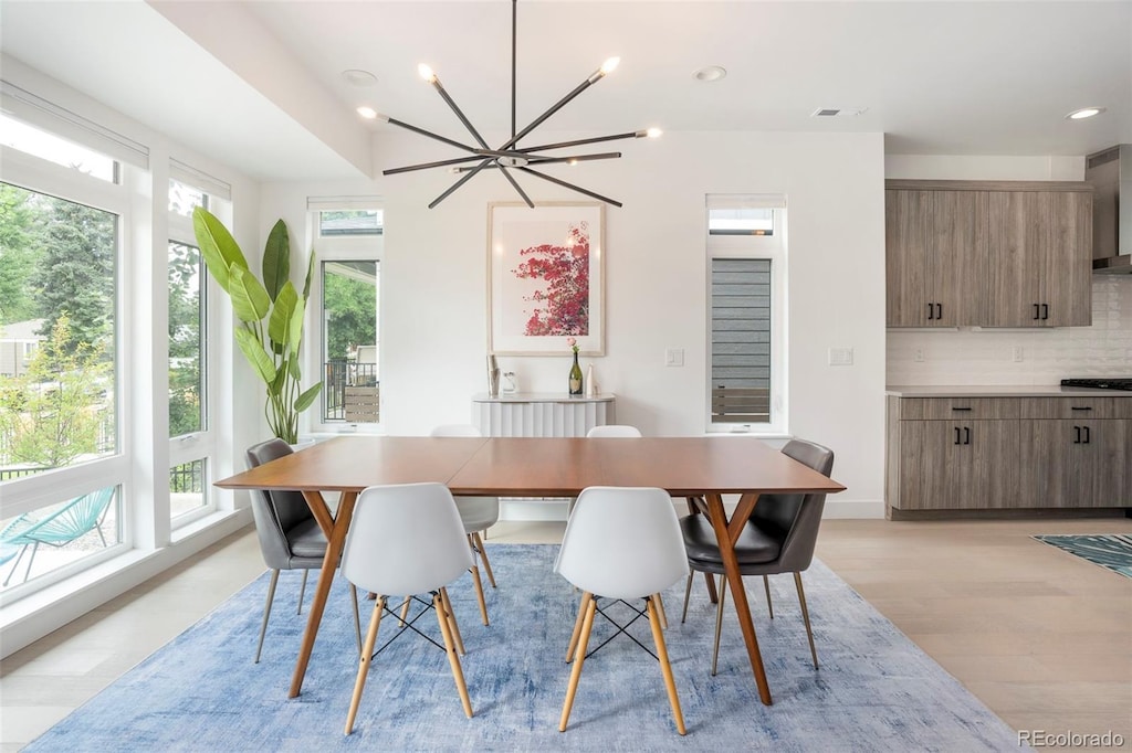 dining space featuring a chandelier and light hardwood / wood-style flooring