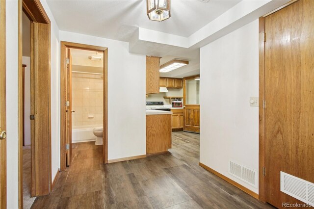 10469 Christopher Dr, Conifer, CO 80433 - kitchen with light countertops, baseboards, wood finished floors, and brown cabinetry