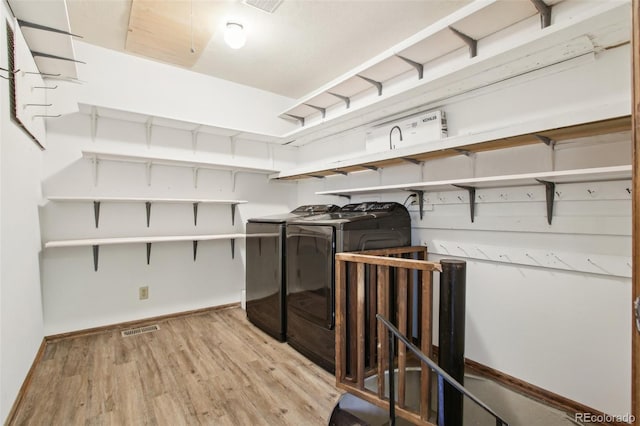 10469 Christopher Dr, Conifer, CO 80433 - laundry room with independent washer and dryer, light wood-type flooring, and baseboards