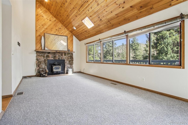 10469 Christopher Dr, Conifer, CO 80433 - unfurnished living room featuring a wood stove, carpet flooring, baseboards, wooden ceiling, and high vaulted ceiling