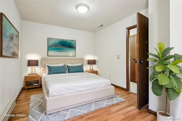 10469 Christopher Dr, Conifer, CO 80433 - bedroom with wood finished floors, baseboard heating, and baseboards