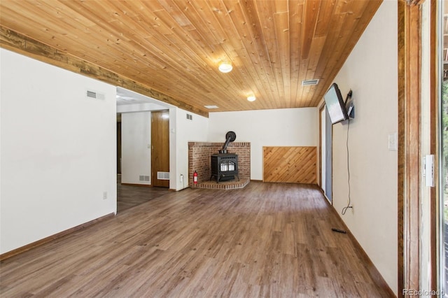 10469 Christopher Dr, Conifer, CO 80433 - unfurnished living room featuring wood ceiling, wood finished floors, and a wood stove