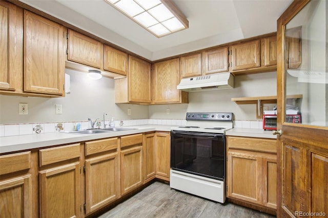 10469 Christopher Dr, Conifer, CO 80433 - kitchen featuring range with electric cooktop, under cabinet range hood, a sink, light wood-style flooring, and light countertops