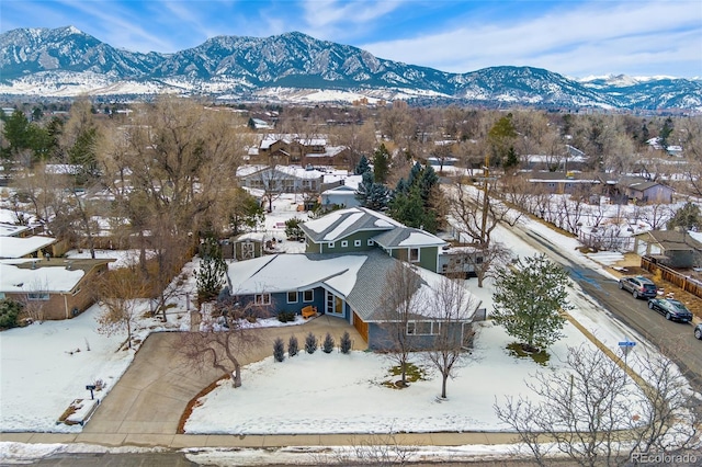 snowy aerial view featuring a mountain view