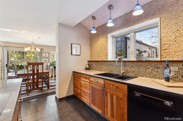 kitchen featuring decorative backsplash, black dishwasher, sink, and hanging light fixtures