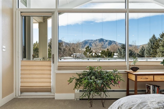 sunroom / solarium with a baseboard radiator and a mountain view