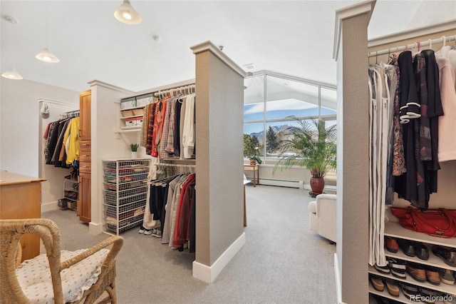 walk in closet featuring light carpet and baseboard heating