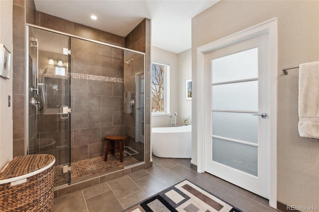 bathroom with tile patterned floors and separate shower and tub