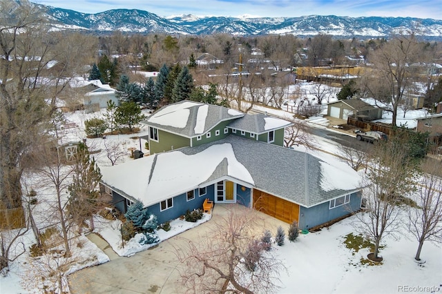 snowy aerial view with a mountain view