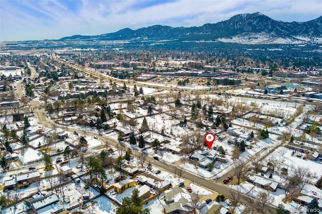 snowy aerial view with a mountain view