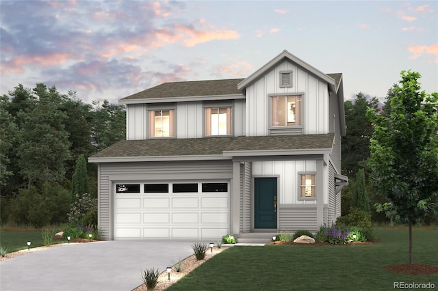 view of front facade with a garage and a yard