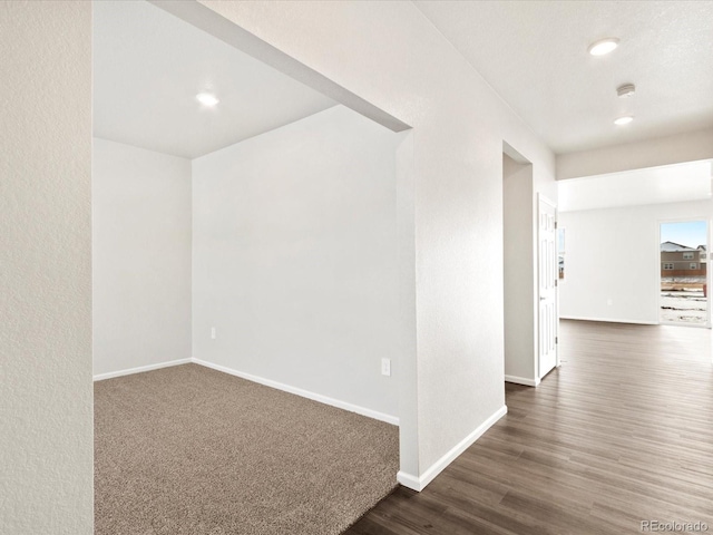 unfurnished room featuring recessed lighting, baseboards, and wood finished floors