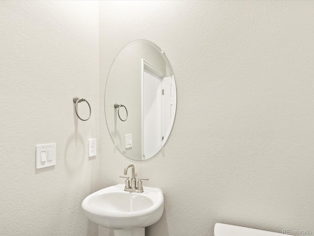 half bath featuring a sink