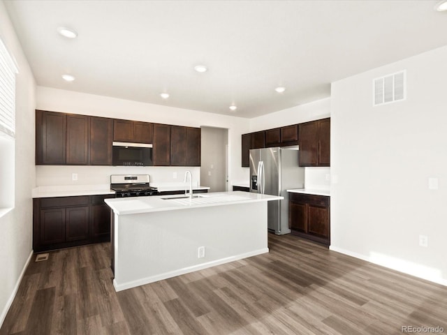 kitchen with visible vents, stainless steel appliances, dark wood-type flooring, and light countertops