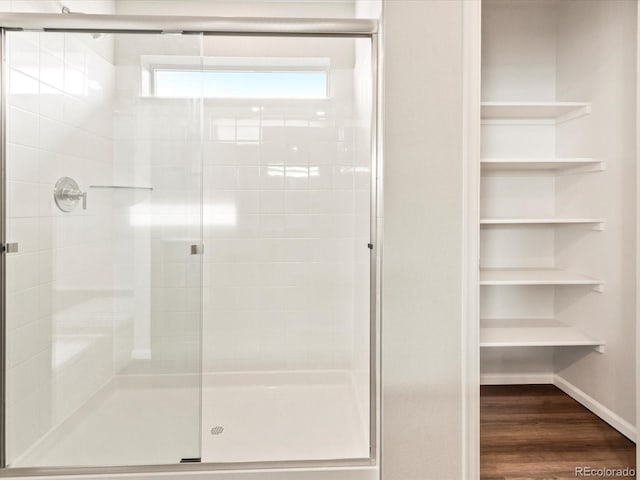 bathroom featuring a stall shower and wood finished floors