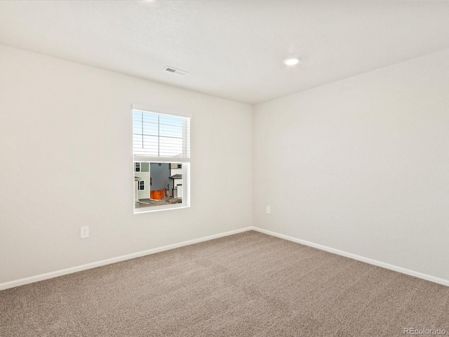 spare room with carpet, visible vents, baseboards, and recessed lighting