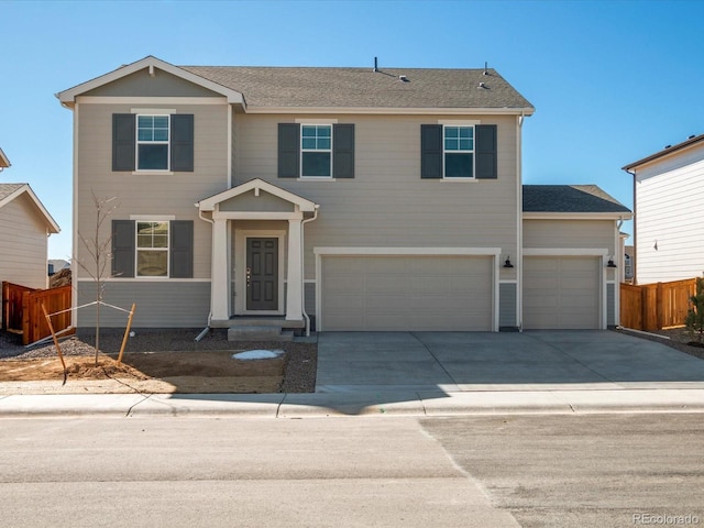 view of front of house featuring a garage, a shingled roof, fence, and concrete driveway