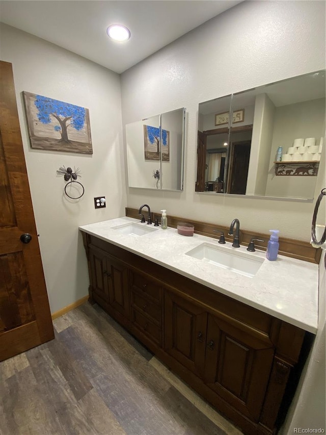 bathroom featuring hardwood / wood-style flooring and vanity