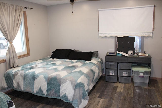 bedroom with dark hardwood / wood-style floors