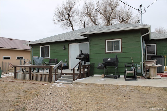 rear view of house featuring central AC unit and a patio