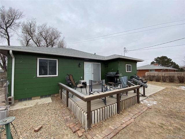 rear view of property with a wooden deck