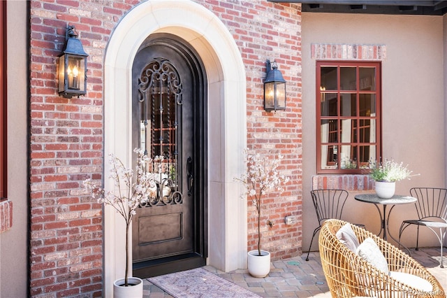 property entrance with brick siding
