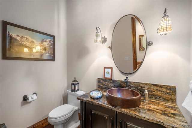 half bath featuring toilet and vanity