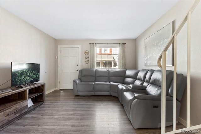 living area with wood finished floors and baseboards