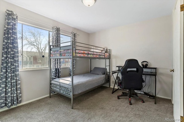 bedroom featuring baseboards and carpet