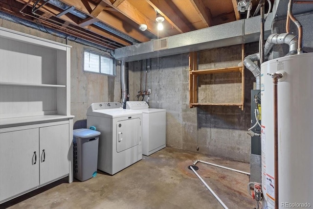 below grade area with water heater, visible vents, and separate washer and dryer