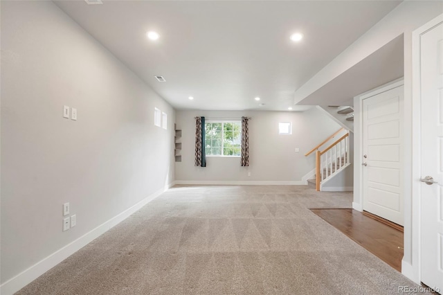 interior space featuring light carpet