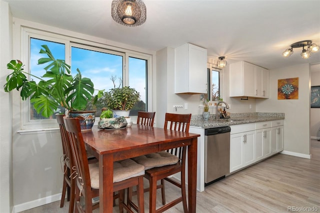 2954 E 101st Ave, Thornton, CO 80229 - kitchen with dishwasher, a sink, baseboards, and white cabinetry