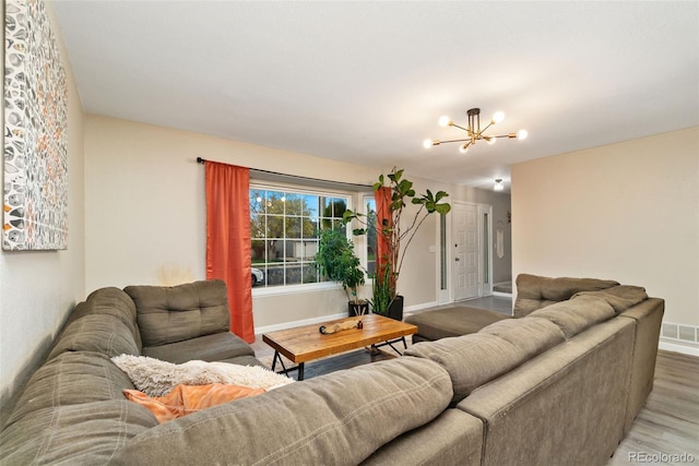 2954 E 101st Ave, Thornton, CO 80229 - living area featuring wood finished floors, a chandelier, and baseboards
