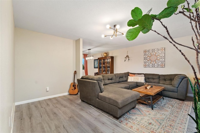 2954 E 101st Ave, Thornton, CO 80229 - living room with a chandelier, wood finished floors, and baseboards