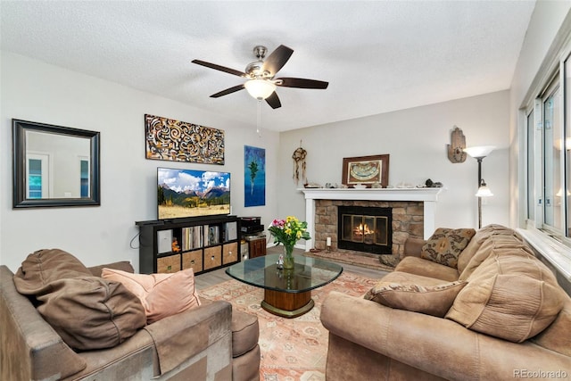 2954 E 101st Ave, Thornton, CO 80229 - living room with ceiling fan, a fireplace, a textured ceiling, and wood finished floors