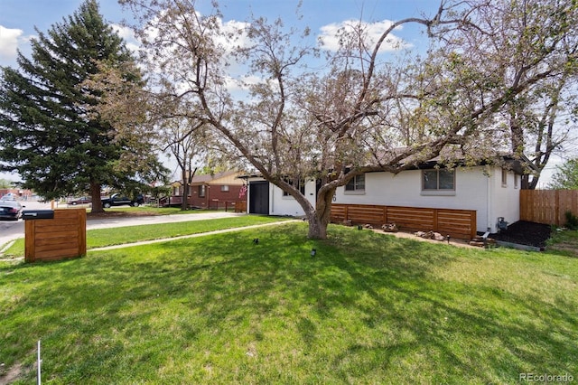 2840 Cottonwood Dr, Denver, CO 80221 - view of front of house featuring a front lawn, driveway, a garage, and fence