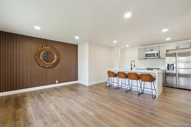 2840 Cottonwood Dr, Denver, CO 80221 - kitchen featuring recessed lighting, a breakfast bar area, stainless steel appliances, and a sink