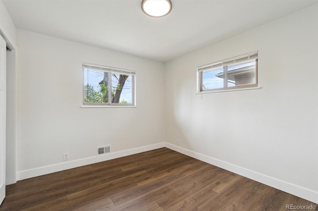 2840 Cottonwood Dr, Denver, CO 80221 - empty room featuring baseboards, dark wood finished floors, and visible vents