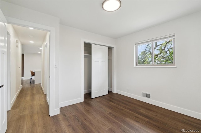 2840 Cottonwood Dr, Denver, CO 80221 - unfurnished bedroom featuring a closet, visible vents, baseboards, and dark wood-style floors