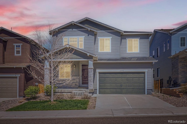craftsman-style house with an attached garage and driveway