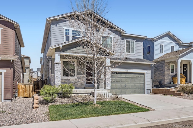 craftsman-style house with fence, an attached garage, stone siding, a porch, and driveway
