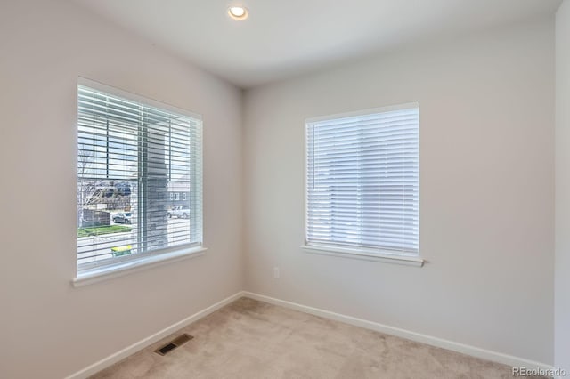 empty room with light colored carpet, baseboards, visible vents, and recessed lighting