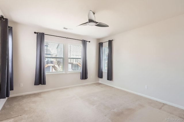 empty room featuring baseboards, plenty of natural light, carpet, and a ceiling fan