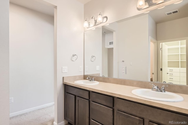 full bath featuring visible vents, a sink, and double vanity